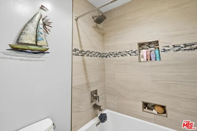 a bathroom with a shower and a toilet