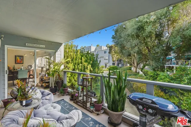 a view of a balcony with chairs and potted plants
