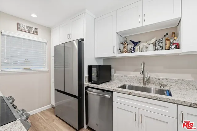 a kitchen with stainless steel appliances a refrigerator and a sink