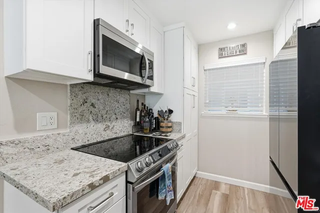 a kitchen with a sink stove and microwave