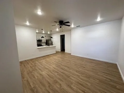 a view of a kitchen with a sink and a refrigerator