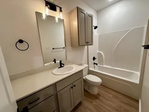 a bathroom with a double vanity sink toilet mirror and shower