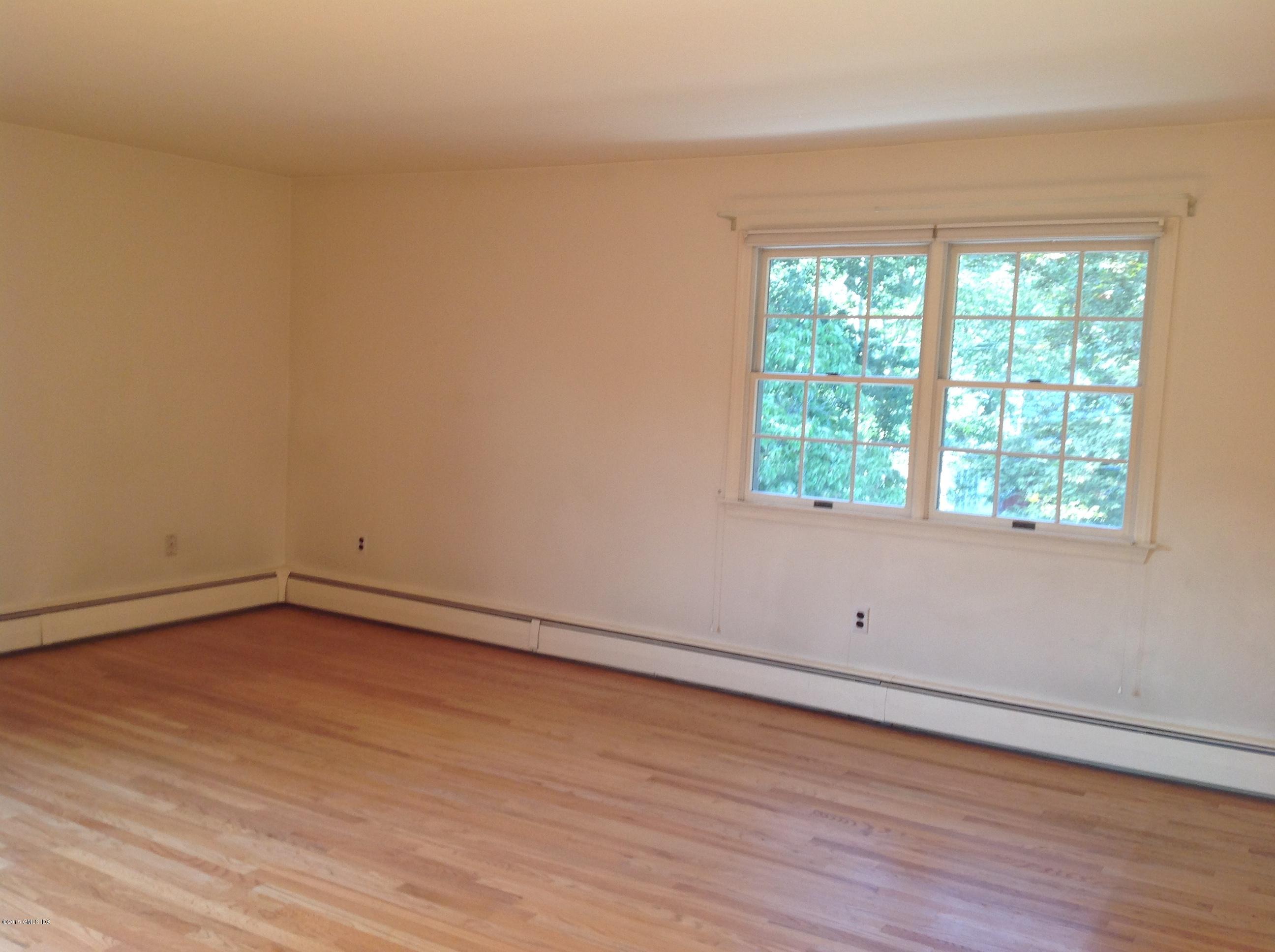 6 Griffith Road Riverside, CT 06878 - Photo 18 of 24 an empty room with wooden floor and window