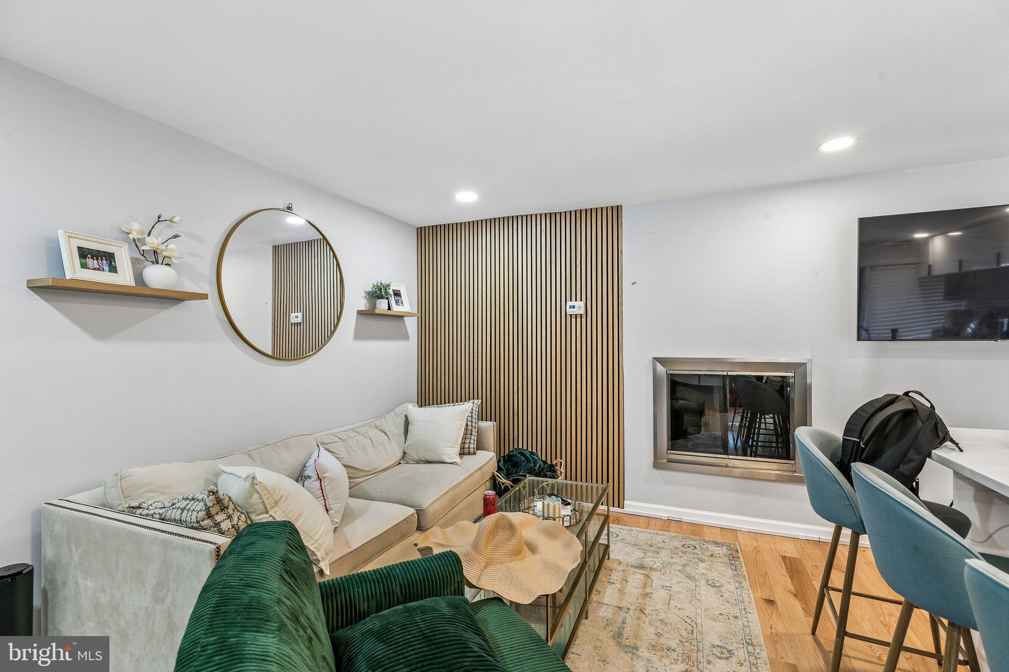 1130 Lombard Street Philadelphia, PA 19147 - Photo 4 of 45 a living room with furniture a fireplace and a flat screen tv