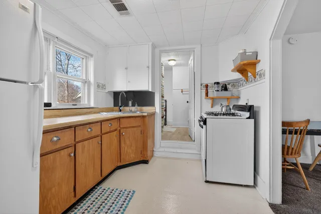 a kitchen with a refrigerator and cabinets