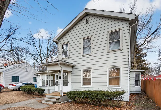 a front view of a house with a garden