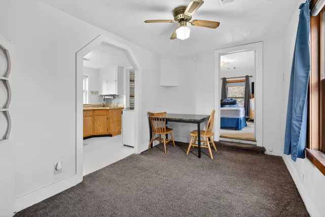 a view of a livingroom with furniture and a kitchen