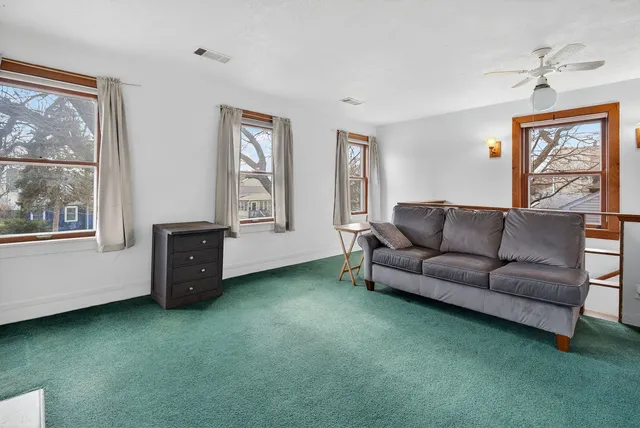 a living room with furniture and a kitchen