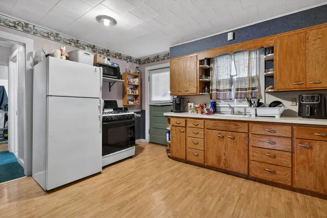 a kitchen with appliances a sink and lots of cabinets