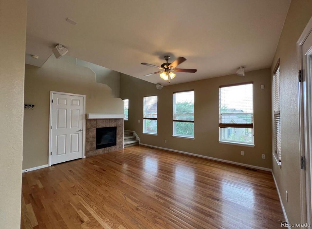 10847 Towerbridge Road Highlands Ranch, CO 80130 - Photo 3 of 14 a view of an empty room with window and wooden floor