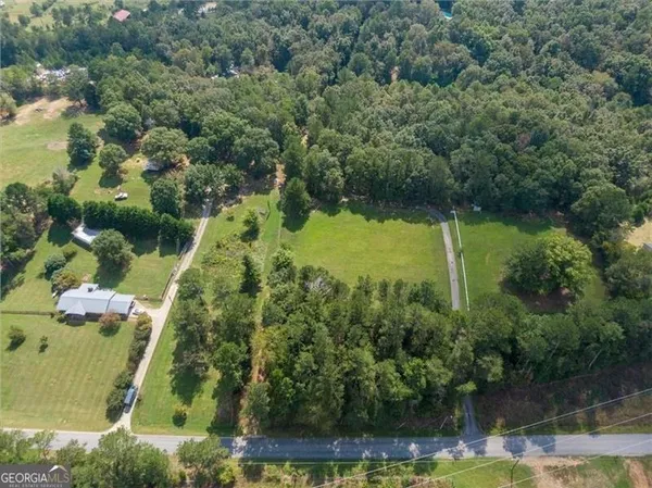 an aerial view of residential house with outdoor space and swimming pool