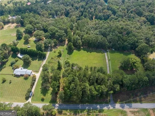 an aerial view of residential house with outdoor space and swimming pool