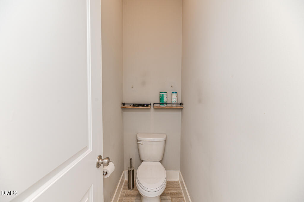 22 Camille Brooks Drive Angier, NC 27501 - Photo 14 of 52 a white toilet sitting in a bathroom