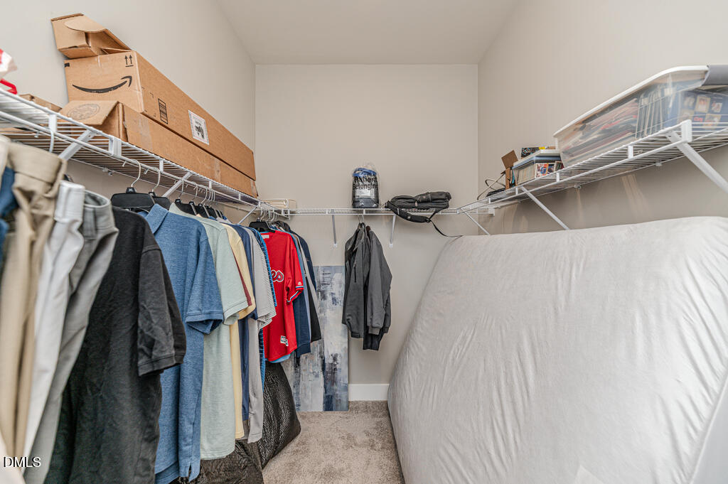 22 Camille Brooks Drive Angier, NC 27501 - Photo 15 of 52 a view of walk in closet with clothes and shoes