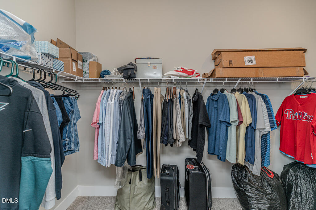 22 Camille Brooks Drive Angier, NC 27501 - Photo 16 of 52 a view of walk in closet with clothes and shoes