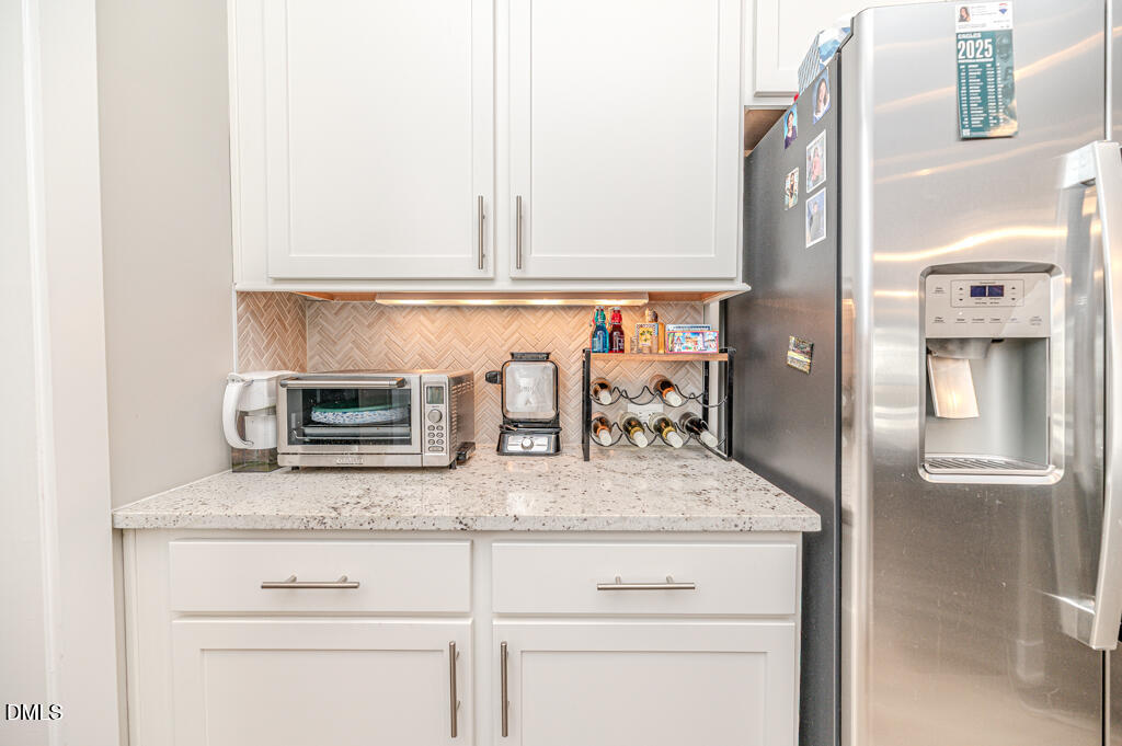 22 Camille Brooks Drive Angier, NC 27501 - Photo 18 of 52 a kitchen with stainless steel appliances granite countertop a sink and cabinets