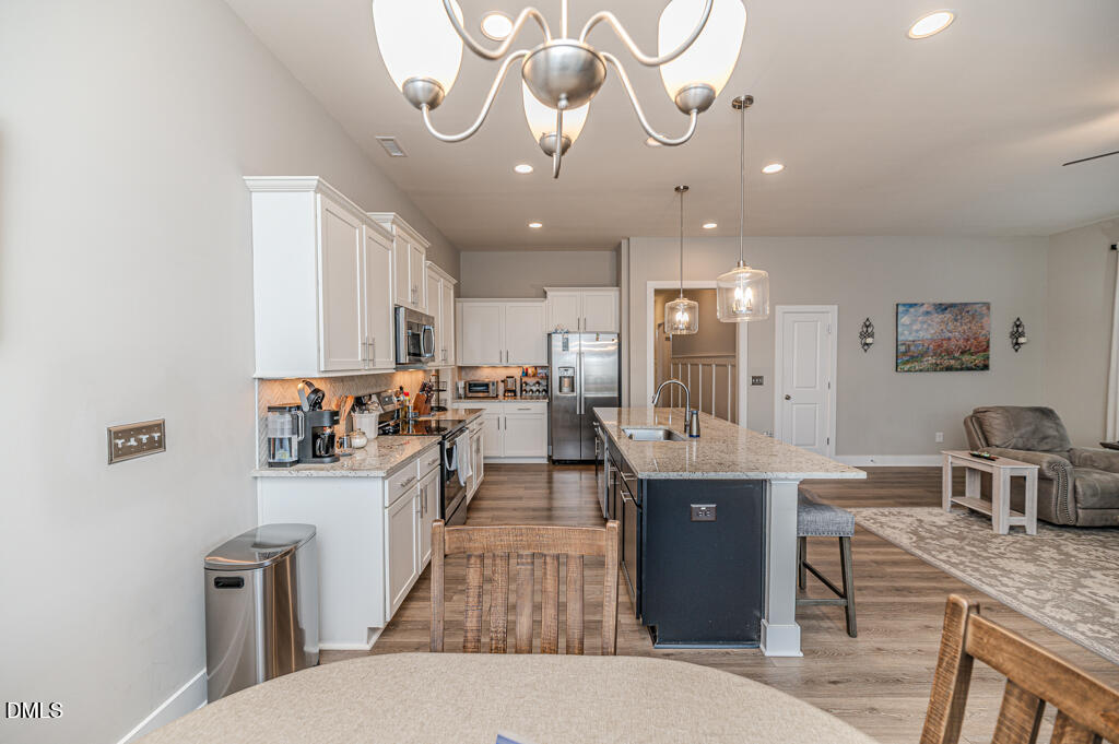 22 Camille Brooks Drive Angier, NC 27501 - Photo 23 of 52 a large kitchen with kitchen island a sink a counter space and stainless steel appliances