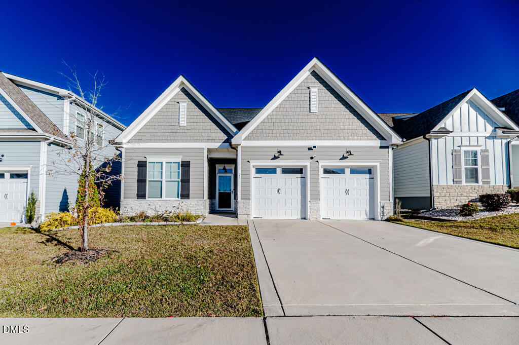22 Camille Brooks Drive Angier, NC 27501 - Photo 3 of 52 a front view of a house with garden