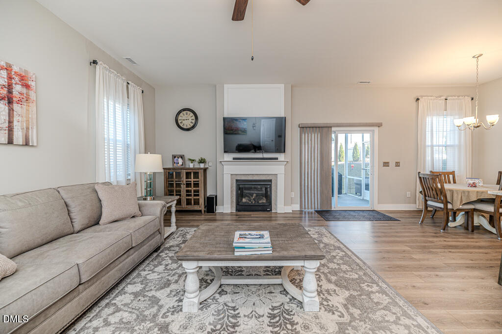 22 Camille Brooks Drive Angier, NC 27501 - Photo 32 of 52 a living room with furniture a window and a fireplace