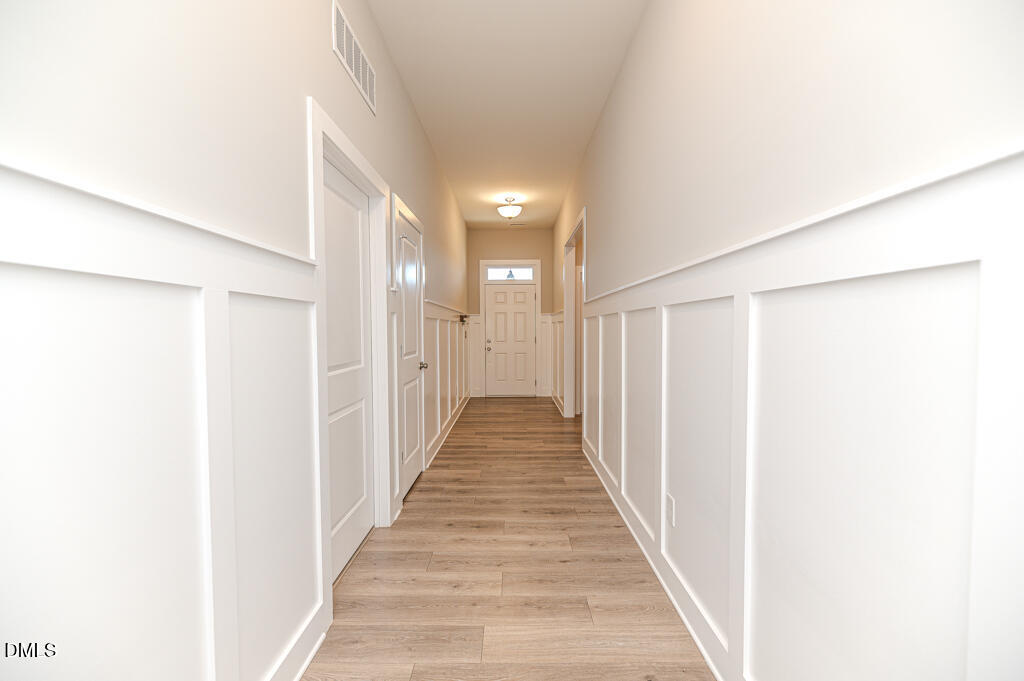 22 Camille Brooks Drive Angier, NC 27501 - Photo 35 of 52 a view of a hallway with wooden floor and staircase