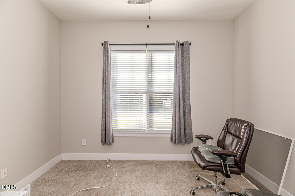 22 Camille Brooks Drive Angier, NC 27501 - Photo 40 of 52 a view of a room with a window and chair