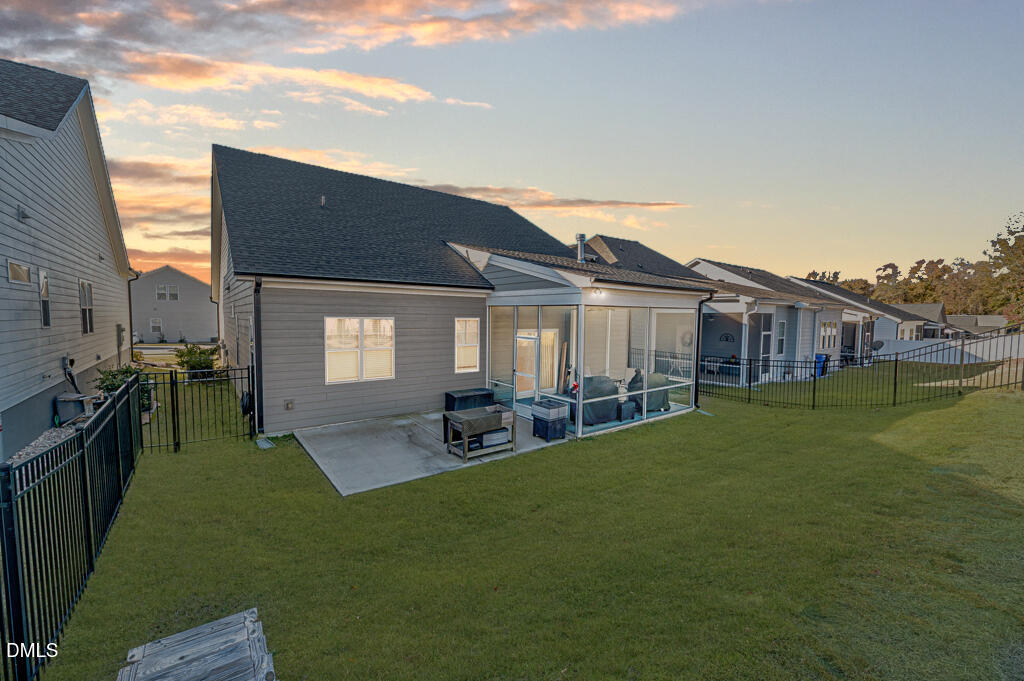 22 Camille Brooks Drive Angier, NC 27501 - Photo 4 of 52 a view of a house with backyard porch and sitting area