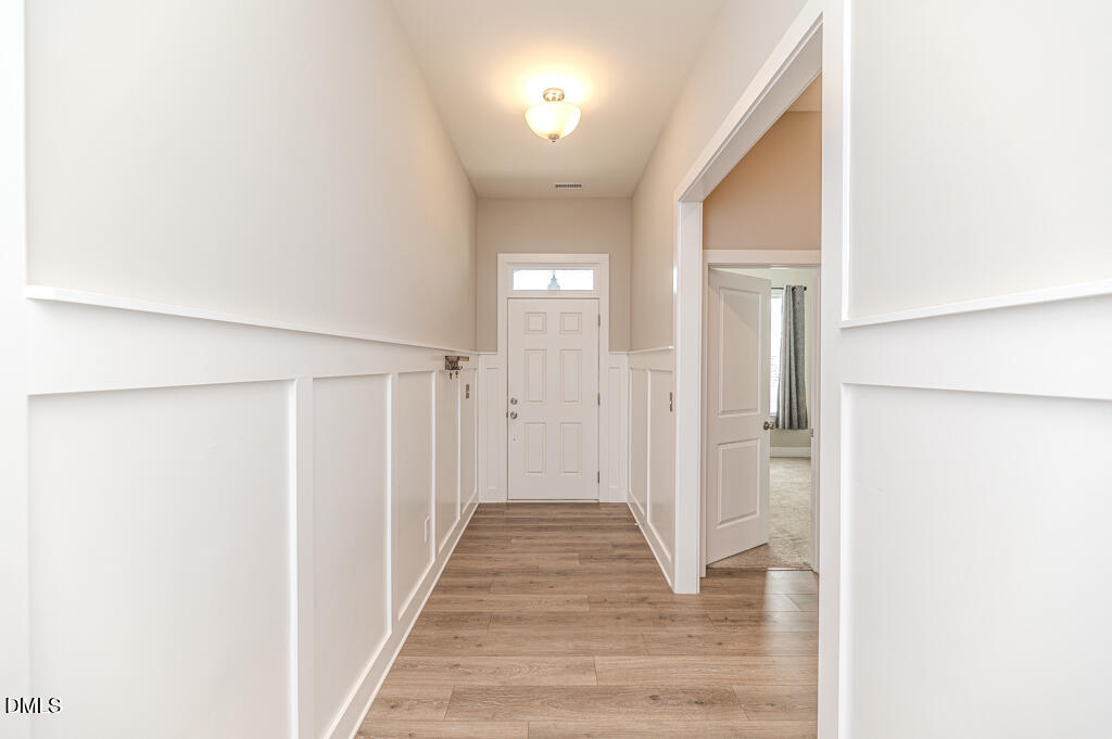 22 Camille Brooks Drive Angier, NC 27501 - Photo 42 of 52 a view of a hallway with wooden floor and a bathroom
