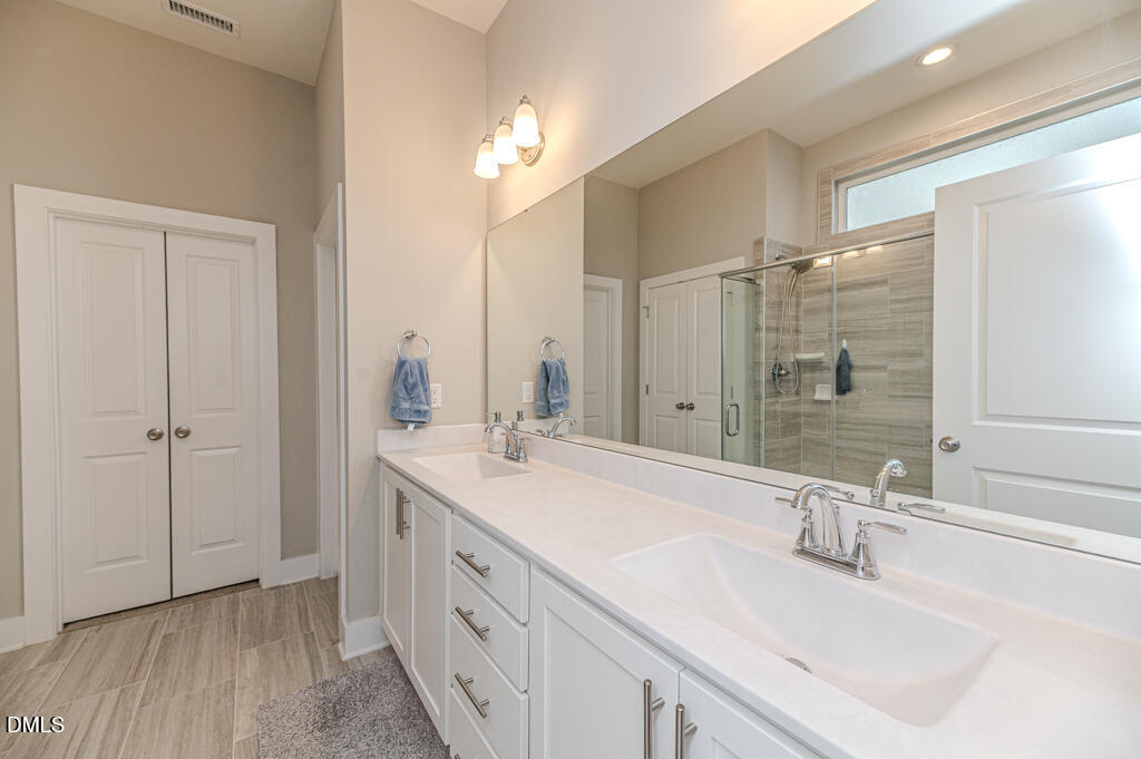 22 Camille Brooks Drive Angier, NC 27501 - Photo 9 of 52 a bathroom with a double vanity sink mirror and double