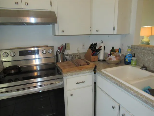 a kitchen with cabinets appliances and a sink