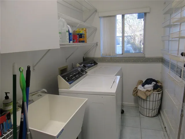a view of walk in closet with window and entryway