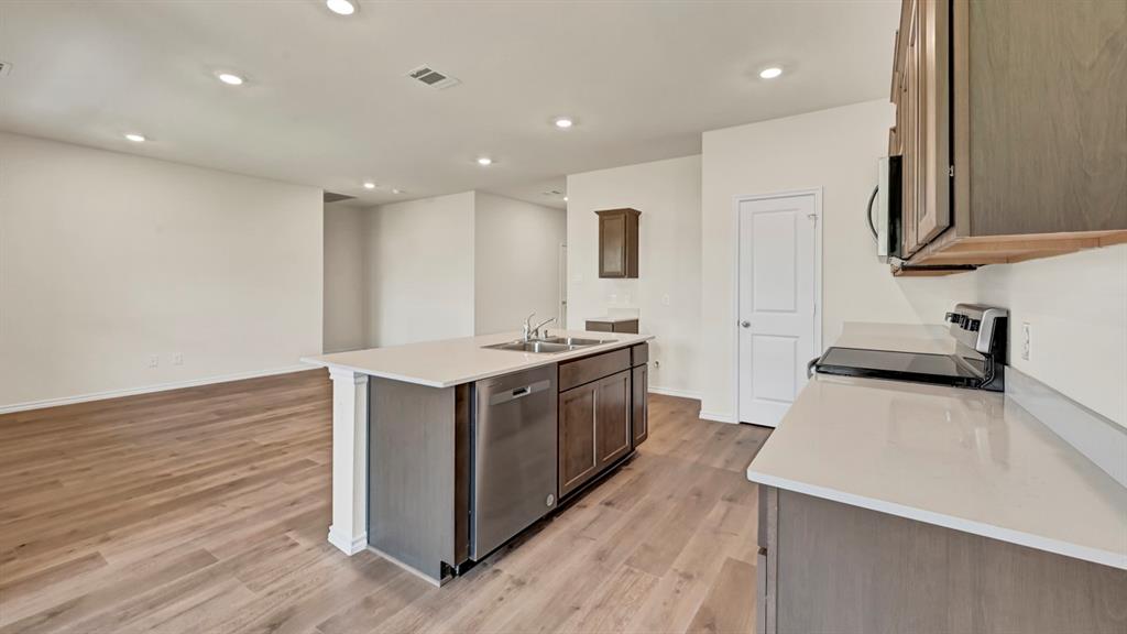 4012 Ripplewood Drive Lindale, TX 75771 - Photo 25 of 37 Open-concept kitchen and living area featuring wood-finish flooring, recessed lighting, and white walls