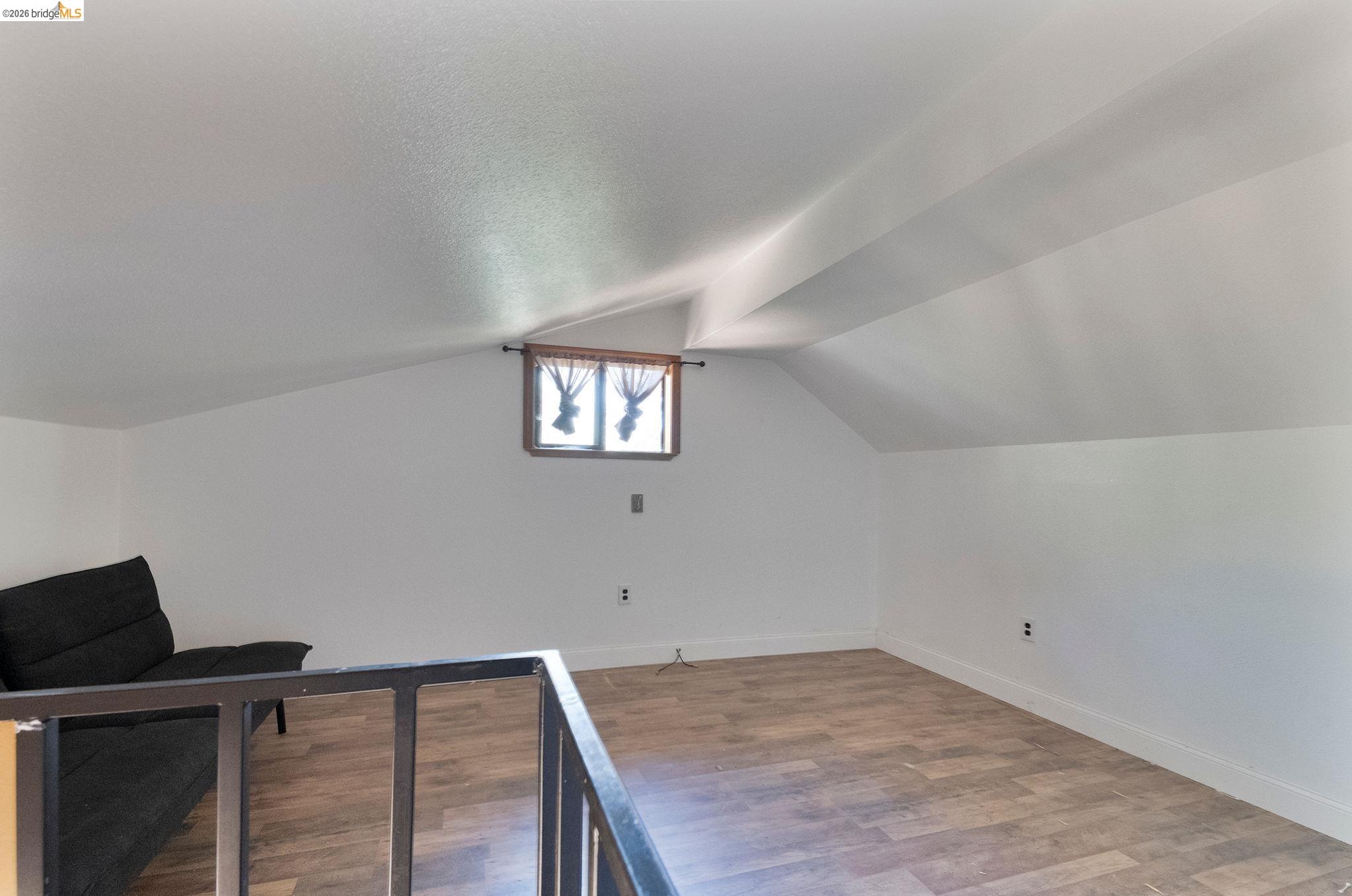 22963 Robertson Ranch Road Sonora, CA 95370 - Photo 63 of 90 Attic space featuring wood-finish flooring and sloped white ceilings