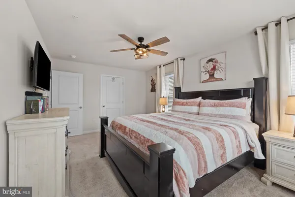 a spacious bedroom with a bed and a chandelier