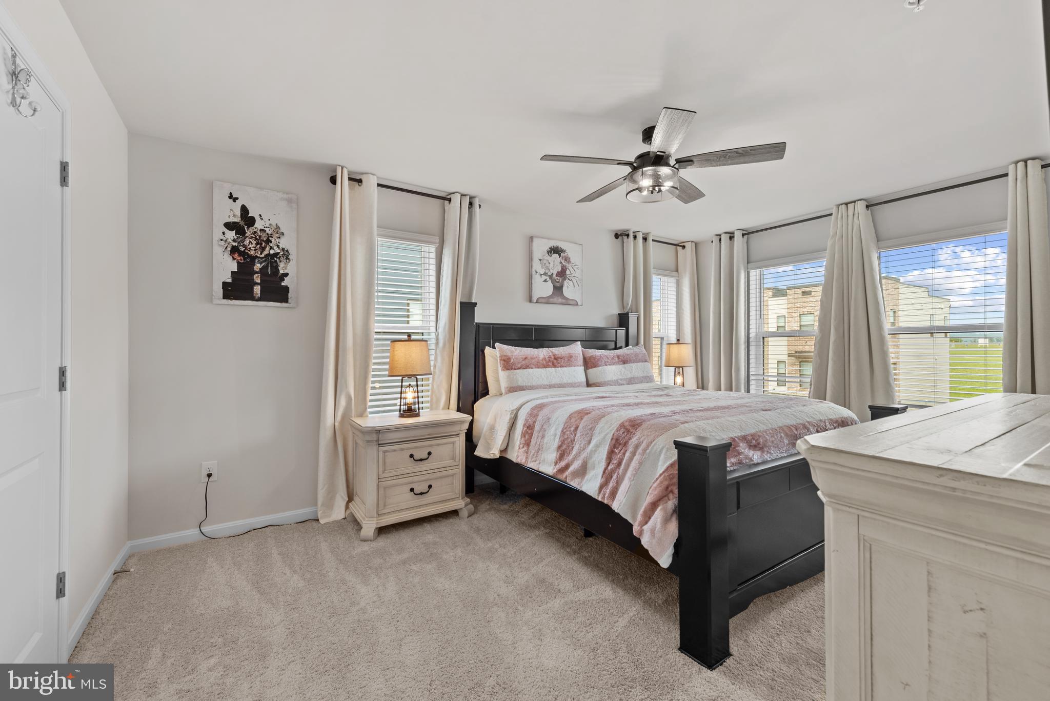 477 Tiller Street Frederick, MD 21701 - Photo 13 of 35 a spacious bedroom with a bed and a chandelier
