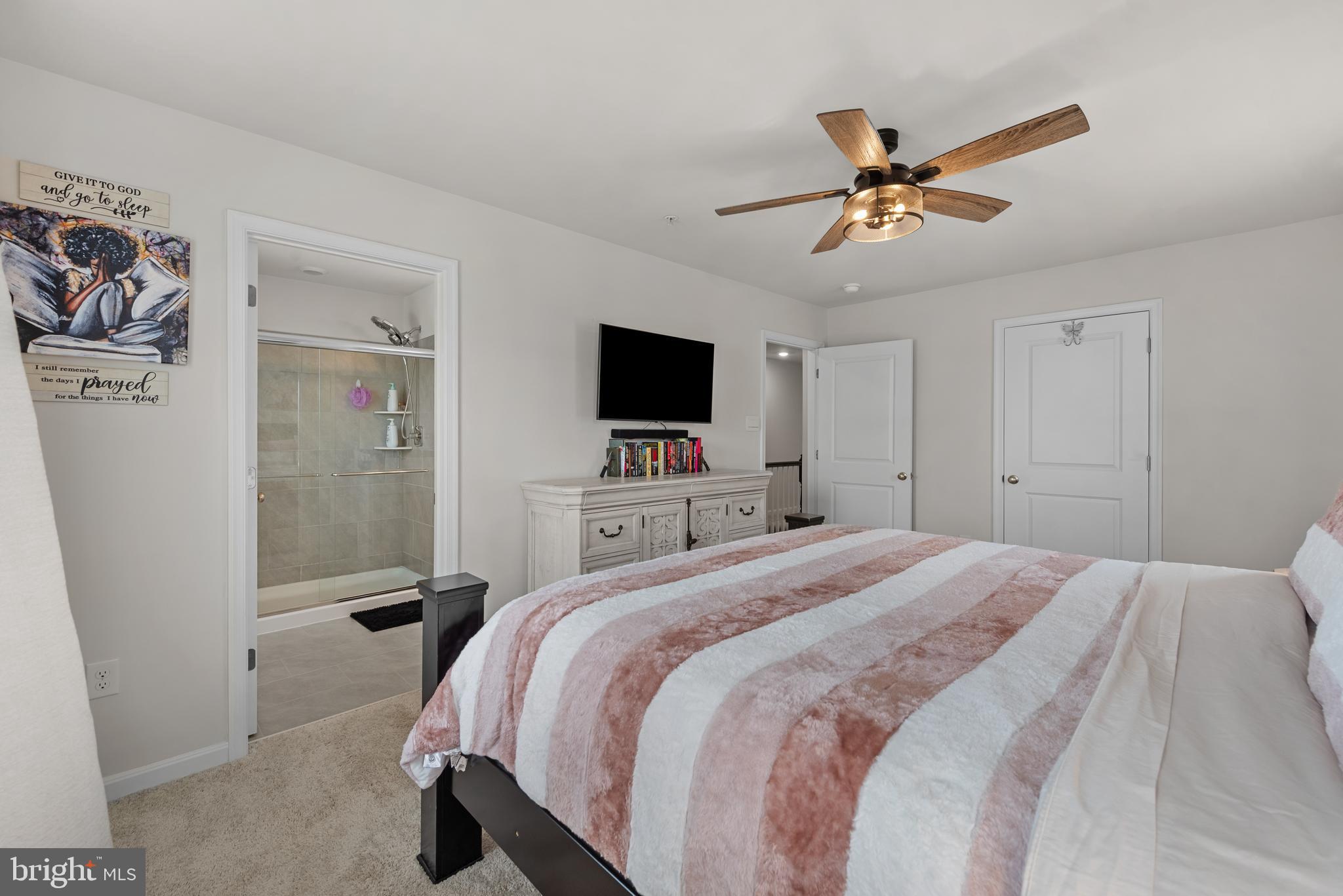 477 Tiller Street Frederick, MD 21701 - Photo 14 of 35 a bedroom with a bed and a flat tv screen on dresser