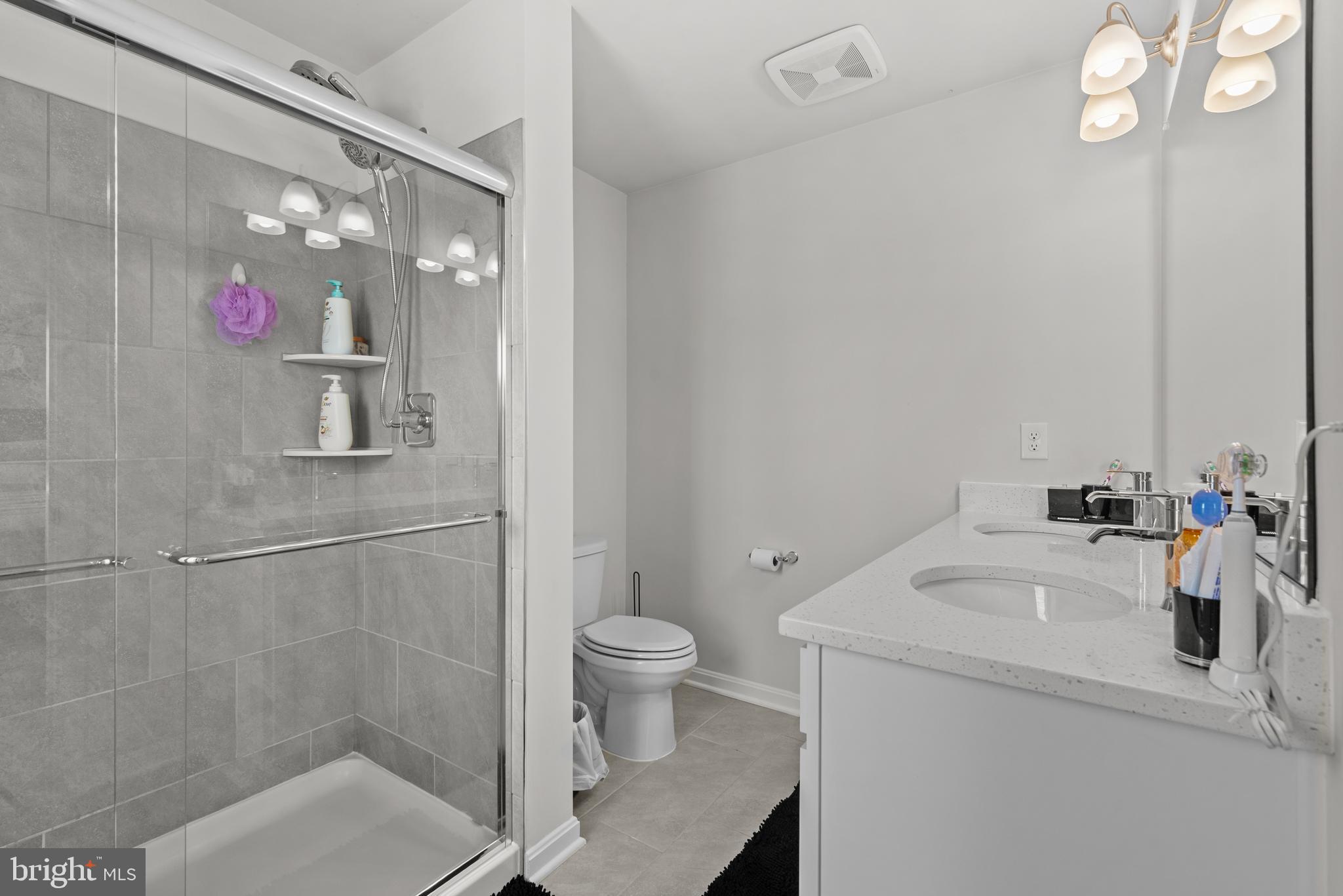 477 Tiller Street Frederick, MD 21701 - Photo 16 of 35 a bathroom with a sink a toilet and shower