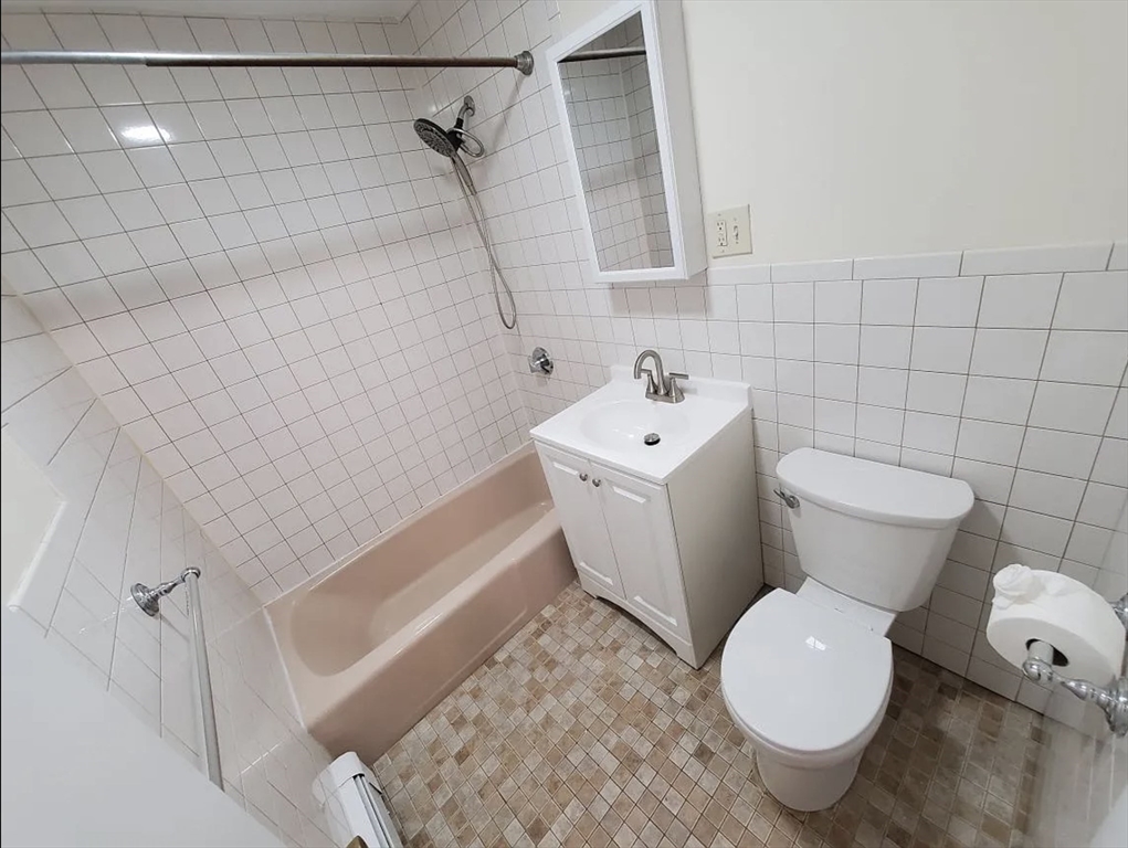 A2 Colonial Drive, Unit 10 Andover, MA 01810 - Photo 11 of 20 a white toilet sitting next to a bath tub