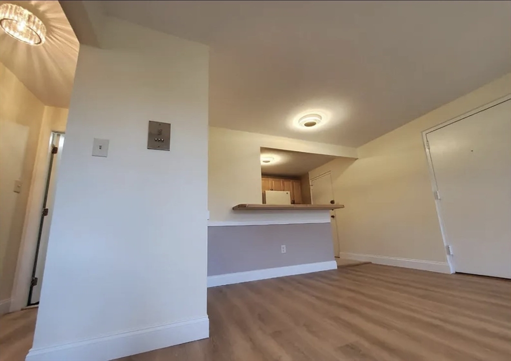A2 Colonial Drive, Unit 10 Andover, MA 01810 - Photo 12 of 20 a view of kitchen and wooden floor