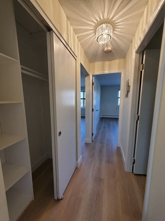 A2 Colonial Drive, Unit 10 Andover, MA 01810 - Photo 13 of 20 a view of hallway with stairs and wooden floor