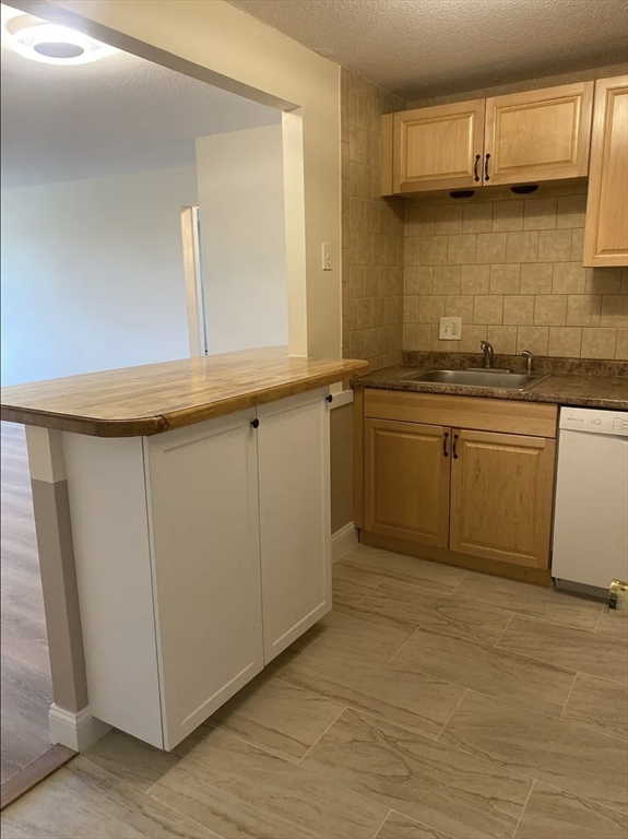 A2 Colonial Drive, Unit 10 Andover, MA 01810 - Photo 4 of 20 a kitchen with stainless steel appliances granite countertop a sink and cabinets