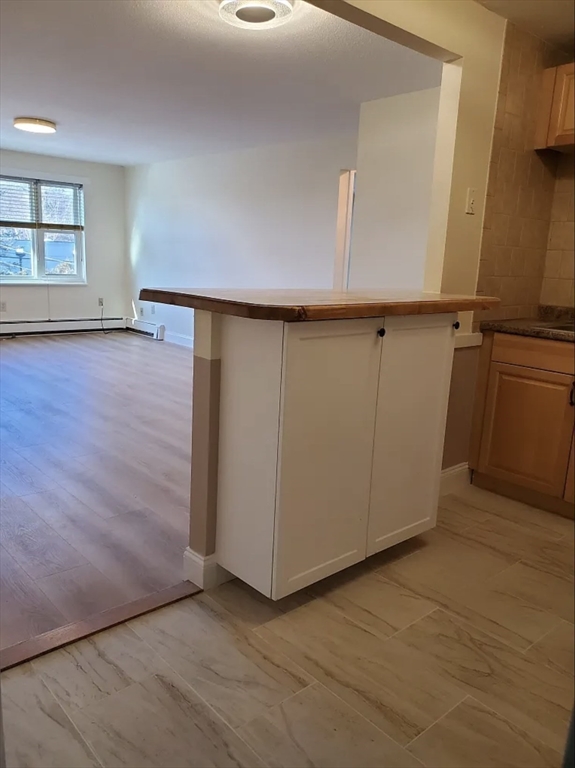 A2 Colonial Drive, Unit 10 Andover, MA 01810 - Photo 5 of 20 an empty room with wooden floor