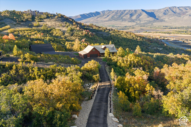 5878 Snowbasin Road Huntsville, UT 84317 - Photo 71 of 90 Expansive property featuring a paved driveway, two-story residence with attached garage, and a secondary structure