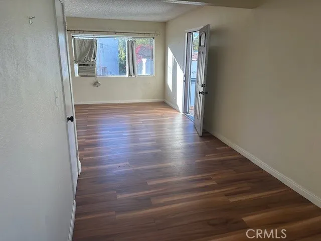 a view of wooden floor and windows in a room