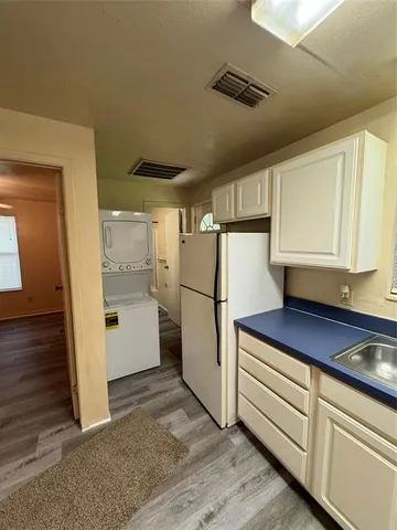 a kitchen with a refrigerator and cabinets