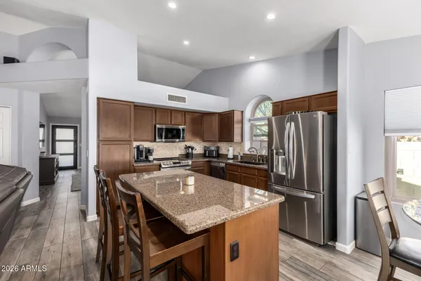 a kitchen with granite countertop cabinets and stainless steel appliances