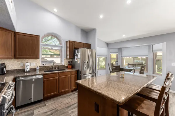 a kitchen with lots of counter space a sink and appliances