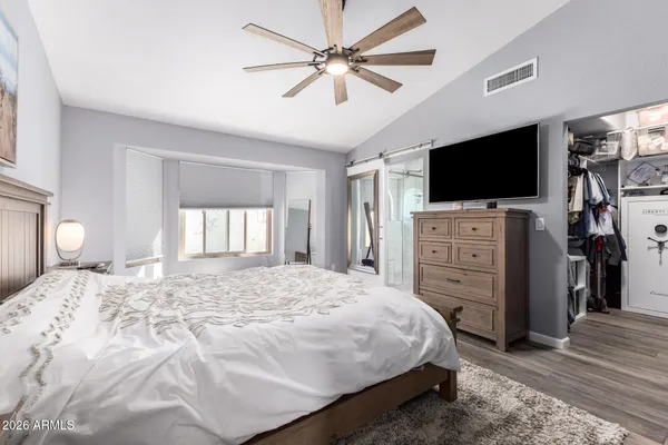 a bedroom with a bed and a flat screen tv