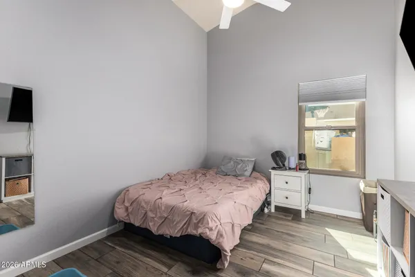 a bedroom with a bed and a window