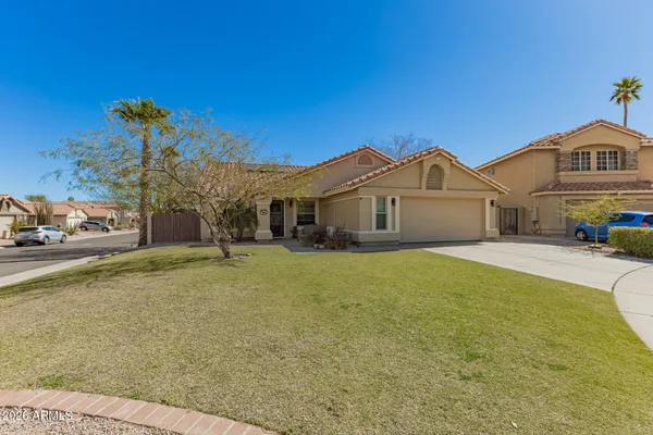 a view of a white house with a large pool and a yard