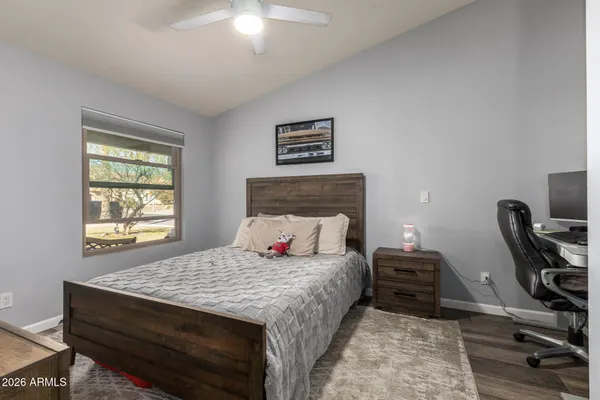 a bedroom with a bed and a chair